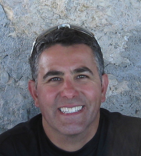 Board Members J. Lopez Smiling With Sunglasses On His Head Wearing A Black T-Shirt